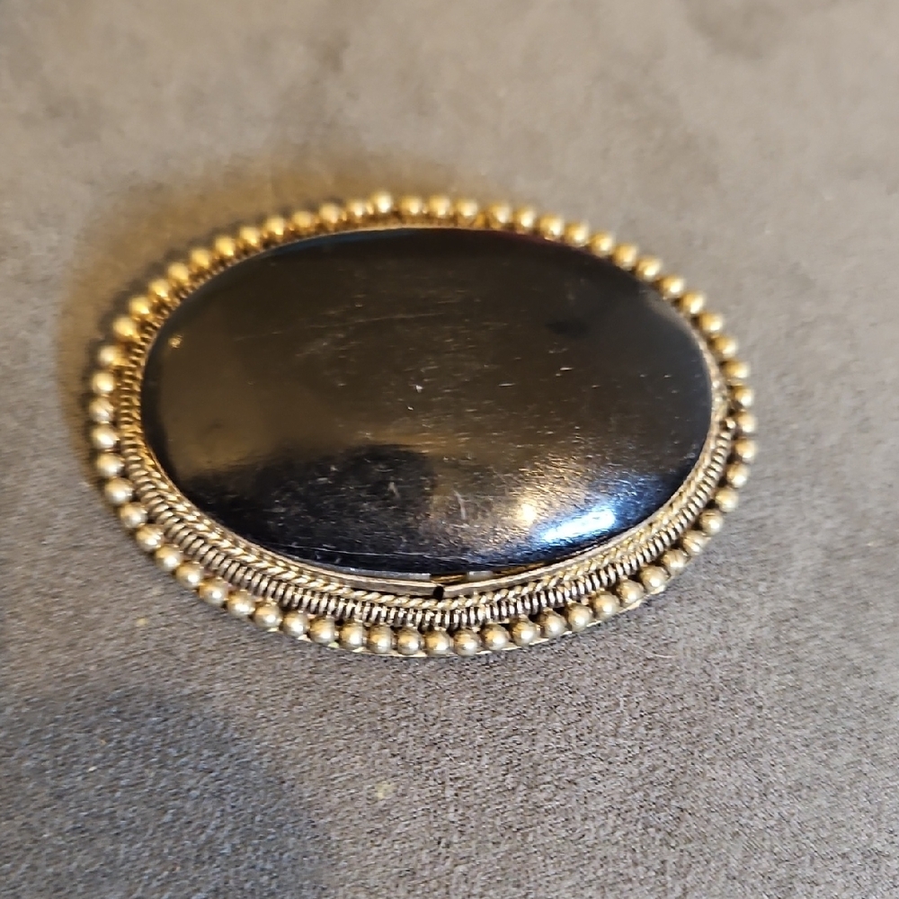 Elegant Black and Gold Brooch